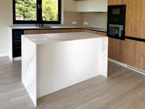 wyspa kuchenna otoczona z trzech stron marmurowym blatem